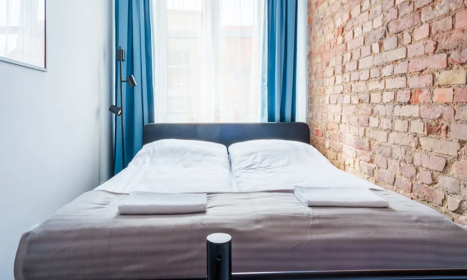 Double bed against the brick wall